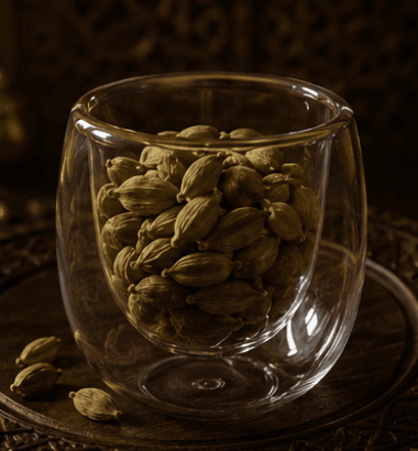 Cardamom pods in a glass cup as a quiet botanical observation